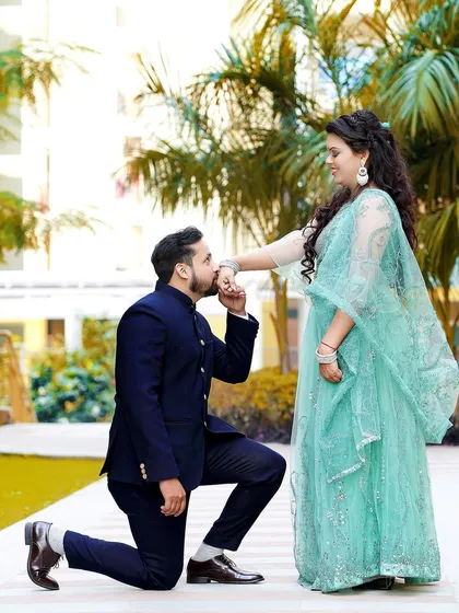 A beautiful outdoor proposal during a Roka ceremony. The groom's gesture and the bride's happy smile say it all.