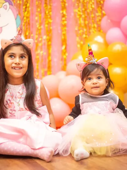 Two little unicorns sitting together. A sweet moment between sisters.