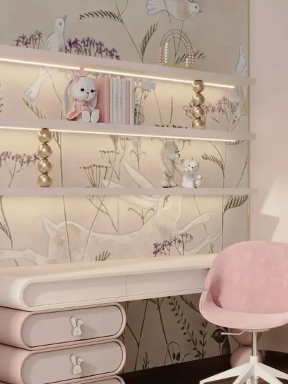 An elegant and whimsical study desk for a child's room. This setup includes a floating desk with rounded drawers, back-lit shelving, and a beautiful, nature-themed wallpaper.