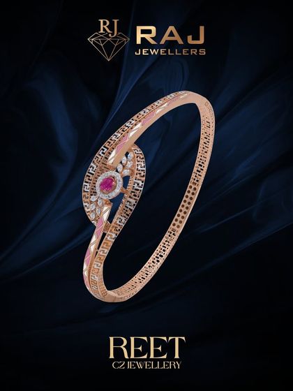 This stylish kada features a swirling design with a central ruby-colored stone, accented with the classic Greek key pattern. The combination of color and texture makes it a standout piece.