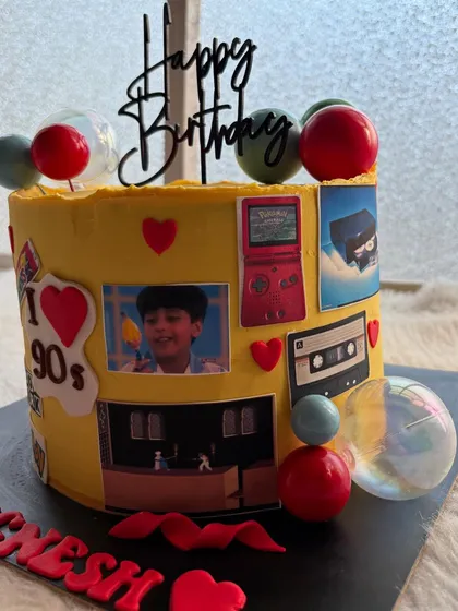 The other side of the 90s cake, featuring a Game Boy and even a personal childhood photo. It's a sweet trip down memory lane.