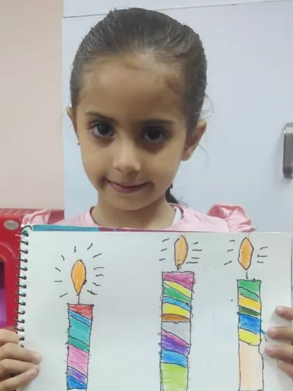 This student's drawing of candles shows a good understanding of color patterns and the concept of light.