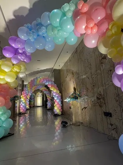 I believe in creating 'wow' moments, and this pastel rainbow balloon tunnel does just that. It provides an immersive and colorful experience for guests as they enter the celebration, making for incredible photos and lasting memories.