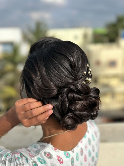 Another angle of the client with her intricate low bun, showing the beautiful outdoor lighting.