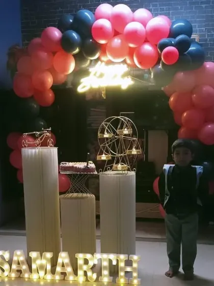 Here’s a fun birthday setup for a young boy, featuring a vibrant pink and black balloon arch. I included a custom neon sign and marquee letters spelling out his name, "SAMARTH", to make him feel like the star of the show.