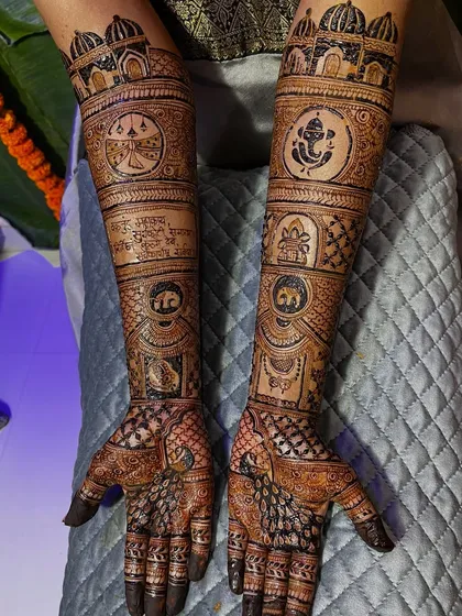 A custom bridal mehendi featuring a Ganesha motif, a shloka, and other auspicious symbols. The design is a beautiful blend of spirituality and artistry.