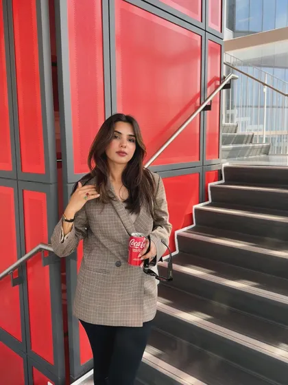 Part of a series, this shot shows a smart-casual college look against a vibrant red wall, demonstrating my eye for color and composition.