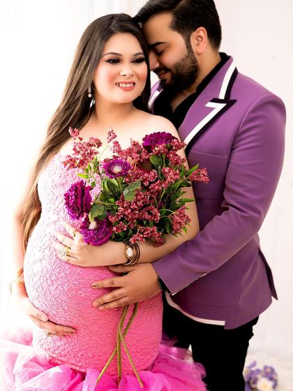 Adding a bouquet of flowers complements the colors of the outfits and adds a soft, romantic touch to the portrait.