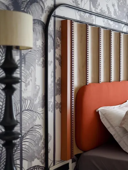 A close-up of the headboard, showing the intricate carvings and upholstery details. This piece is a perfect example of our commitment to bespoke craftsmanship.