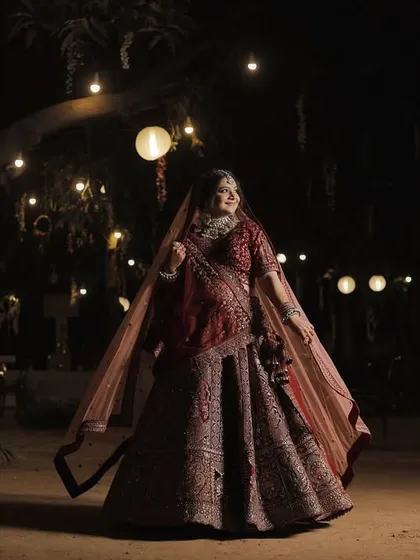 A wide shot showing the bride in her full splendor against a backdrop of festive lights. The overall look is cohesive and grand, fitting for a magnificent wedding celebration.