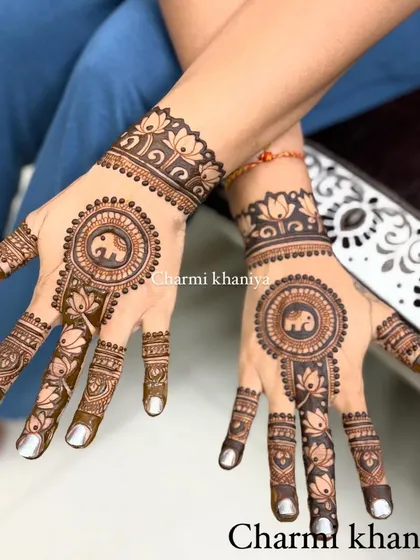 A lovely mandala design that incorporates a cute elephant in the center. The fingers are decorated with lotus motifs, blending several beautiful traditional elements.