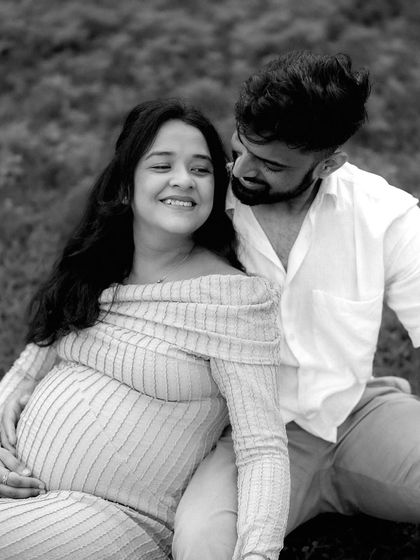 A sweet black and white portrait of the couple sitting together. The way they are looking at each other, sharing a smile, perfectly captures their deep connection.