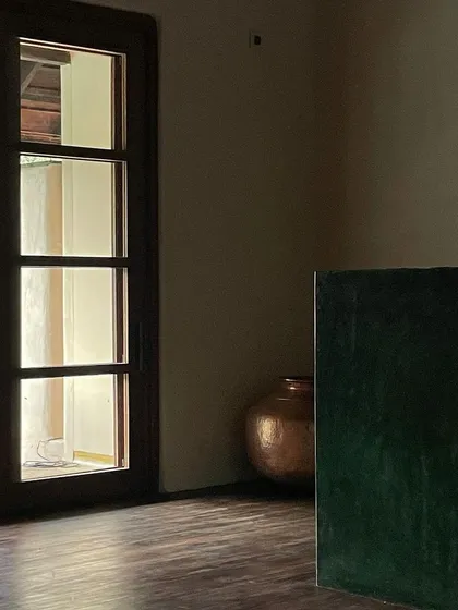 A simple, elegant detail in the Malenadu House, showcasing the interplay of light, wood, and plaster.