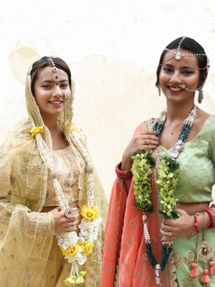 I love creating varmalas that perfectly match a couple's style. This image shows two more unique designs, one with white and yellow flowers and another with beautiful green orchids.