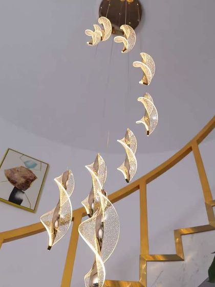 A view from below of the spiral acrylic pendants, showing how they create a vortex of light. A stunning choice for a double-height space.