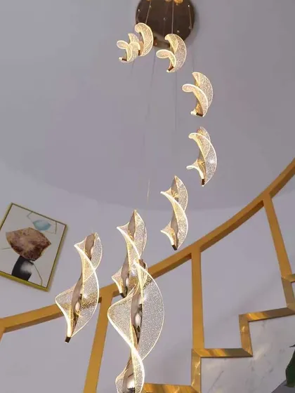 A view from below of the spiral acrylic pendants, showing how they create a vortex of light. A stunning choice for a double-height space.