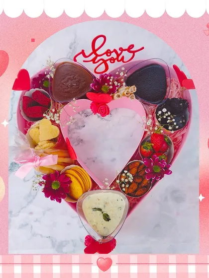 A customized heart-shaped gourmet hamper for Valentine's Day. This lavish gift includes a variety of sweet and savory treats, all presented in a beautiful heart-shaped box.