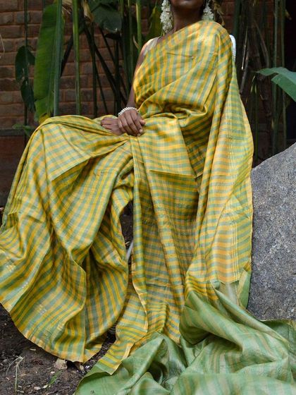 The Genda Phool Kosa Silk Saree, with its beautiful checks and stripes, is a testament to the skill of our weavers. It's a piece of art that you can wear.