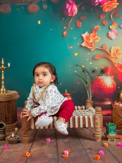 This little one looks so regal sitting on a miniature charpai. Our traditional Indian-themed setups are rich in color, culture, and beautiful details.