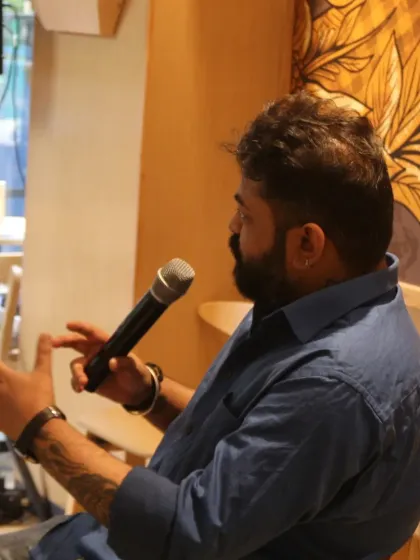 A side profile captures author Oninthough mid-sentence, emphasizing the storytelling aspect of our literary events.