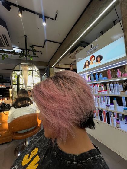 This baby pink color on a short, textured haircut is the perfect summer vibe. The dark undercut adds a cool, edgy contrast.