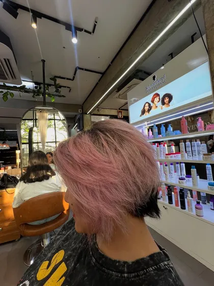 This baby pink color on a short, textured haircut is the perfect summer vibe. The dark undercut adds a cool, edgy contrast.