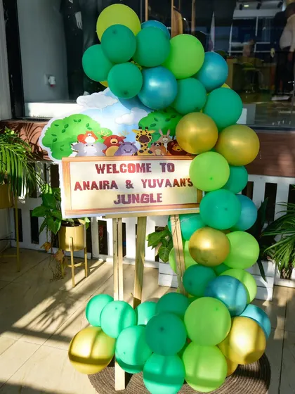 A personalized easel welcomes guests to Anaira and Yuvaan's jungle adventure.