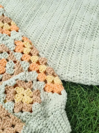 A close-up detail of the sleeve on the granny tee. You can see the beautiful texture of the stitches and the neat joins between the squares.