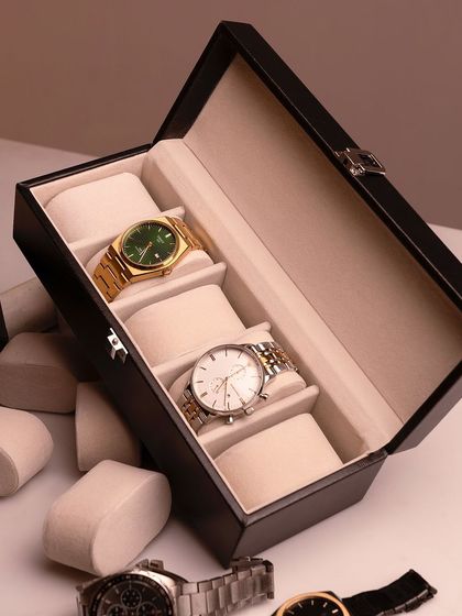 A deconstructed shot of the watch box, showing the watches and cushions arranged artfully. This gives a detailed look at the product's features.