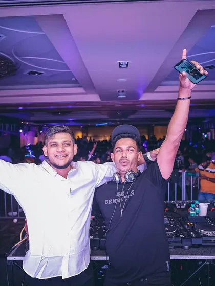 The energy is contagious. A great shot with a fellow DJ at a major corporate event.