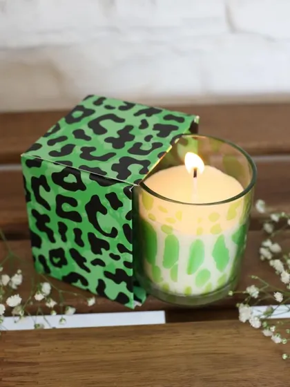 A bold and playful scented candle with a bright green leopard print. This piece is designed to add a pop of color and personality to any room, while filling it with a delightful fragrance.