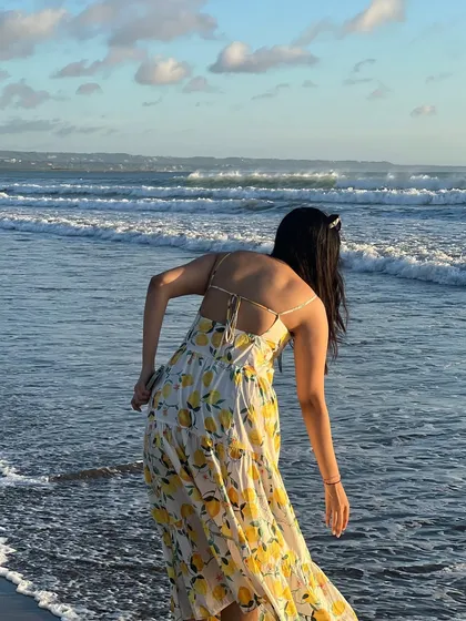 The back of this lemon-print dress has a lovely tie-up detail, adding a stylish touch to a simple sundress.