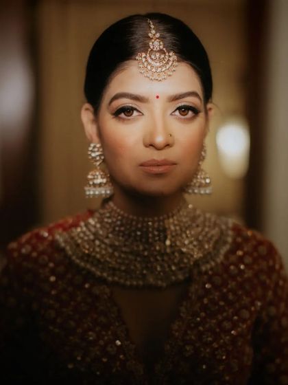 A regal and royal portrait. This close-up shot showcases the clean lines of the eye makeup and the flawless skin finish, creating a powerful and elegant bridal look.