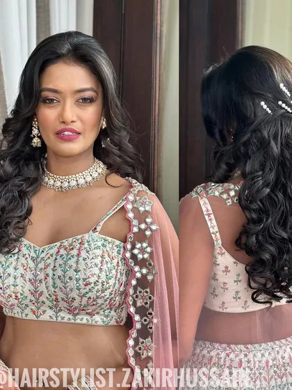 A beautiful half-up style with tight, bouncy curls, accented with pearl pins. A lovely look for a Sangeet or engagement.