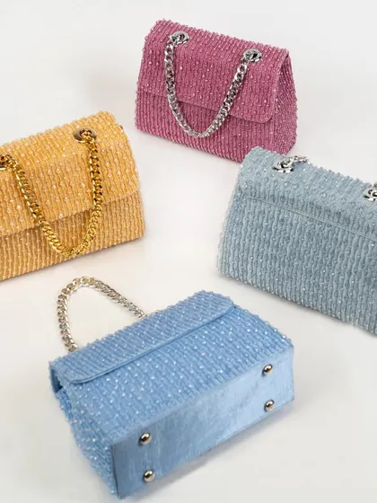 An overview of my crystal bag collection, available in beautiful pastel shades like pink, yellow, and blue. Each bag is fully handcrafted with crystal beads and features a classic chain strap.