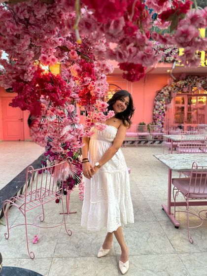 Another shot from this dreamy cafe. The simplicity of the white dress looks so beautiful against the vibrant pink flowers.