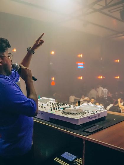 On the microphone, getting ready to hype the crowd. Vocal interaction is a huge part of my performance style as a DJ and entertainer.