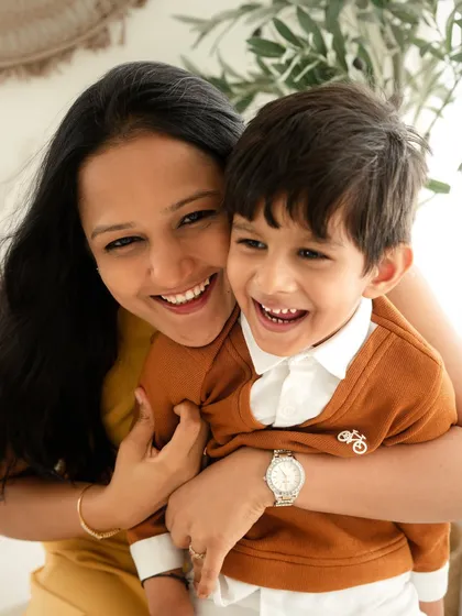 A mother and her son share a huge, happy laugh. Capturing these genuine moments of connection is what makes a family photoshoot so special.