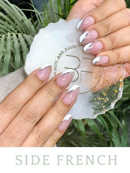 The side French is a subtle, asymmetrical twist. A thin line of color sweeps along one side of the nail, creating a minimalist yet modern look, shown here in white and silver.