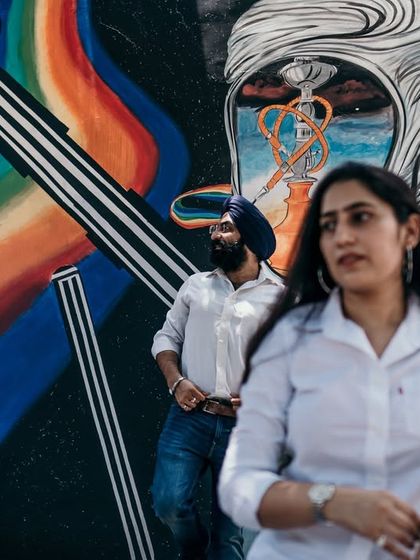 Using vibrant street art as a backdrop adds a splash of color and personality to this urban pre-wedding shoot. It shows the couple's modern style and connection to the city's creative energy.