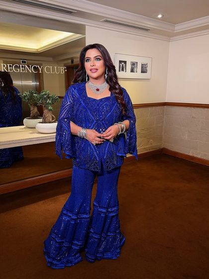 A client looking chic and graceful in the Active Blue Sharara and cape set.