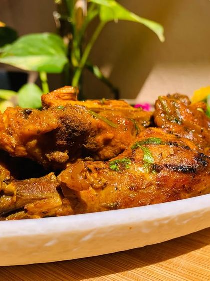 A beautifully plated chicken curry, garnished and ready to eat.