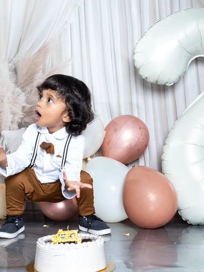 Celebrating the big TWO! This toddler is having a blast at his second birthday party.