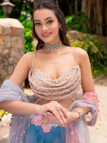 A smiling portrait in the multi-colored "Rang" lehenga. I styled this with a simple emerald choker to let the vibrant colors of the outfit shine.