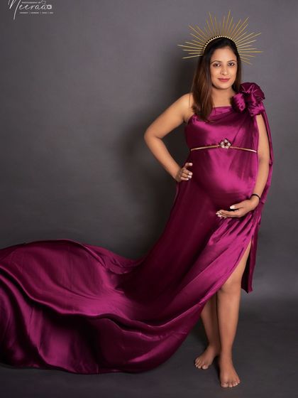 A full-length shot showing off the gorgeous trail of the gown. This pose is all about feeling glamorous and powerful during your pregnancy.