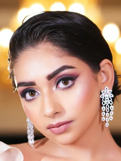 A stunning close-up of a model with dramatic purple smokey eyes and a wet-look hairstyle.