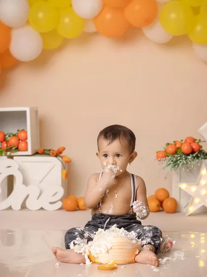 The three stages of a cake smash: cautious curiosity, pure delight, and the "oops, I got caught" look. This little one enjoyed every moment.
