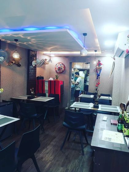 Our restaurant is a small, intimate space. You can see the kitchen in the back, where all the magic happens. It’s designed to feel open and homely.