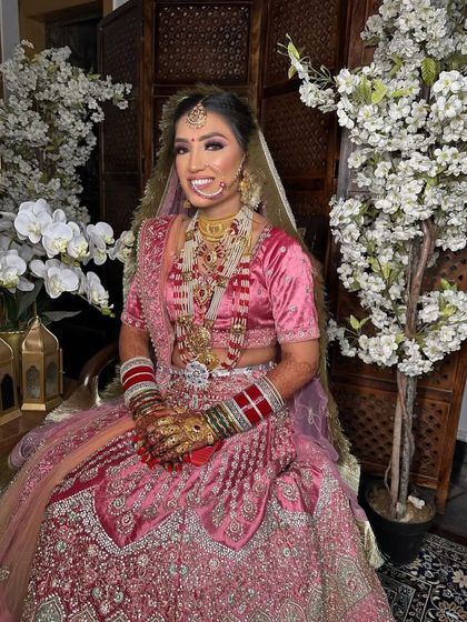 A full-length shot capturing the entire regal look for our bride Anjali. The pink lehenga, heavy jewelry, and flawless makeup create a picture-perfect moment.