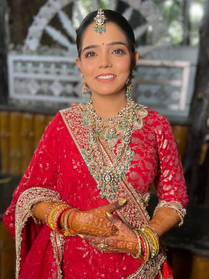 A happy and radiant portrait of my bride, looking absolutely classic in her red wedding attire.